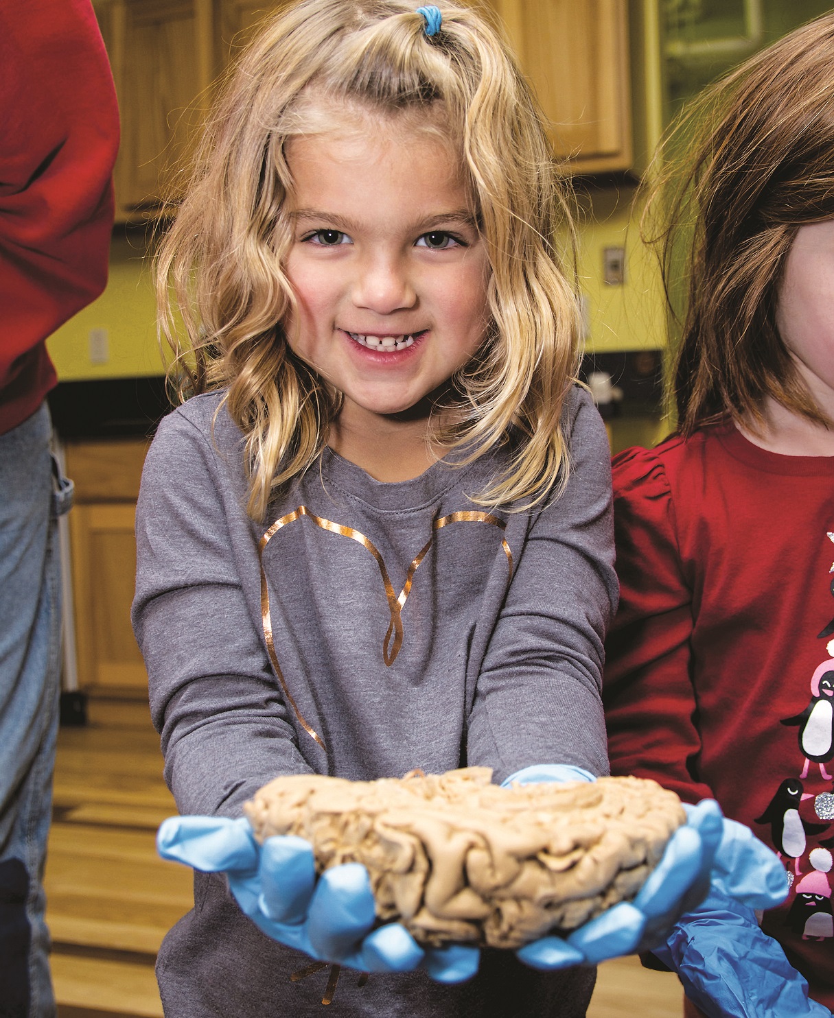Young girl holding human brain.