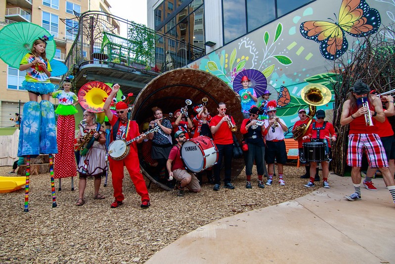 Forward! Marching Band plays music inside the giant wooden bucket, in the outdoor Wonderground exhibit space at Madison Children's Museum